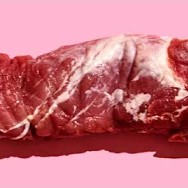 a piece of raw red meat displayed against a pink background