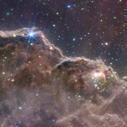 photo from the james webb space telescope, of the 'cosmic cliffs' in the carina nebula