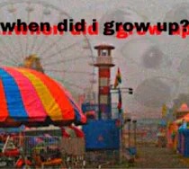 photo of a carnival with brightly colored rides and a dim gray sky, filled with faint eyes. text reads "when did i grow up?"