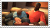 a stamp. the demoman sits on a couch, the soldier is curled up with his head in demo's lap